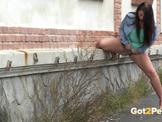 A cute girl peeing in public