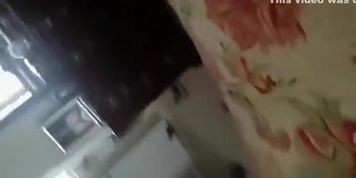 Wife taking off pants in bedroom