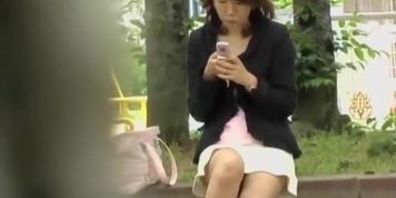 Good looking Asian girl startled by a skirt sharker.