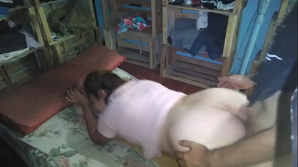 Cute woman in a pink dress has sex in bed on the floor at night