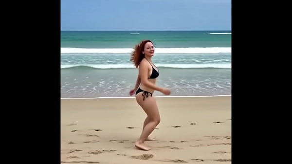 A redhead on the beach running and sitting on the seashore.